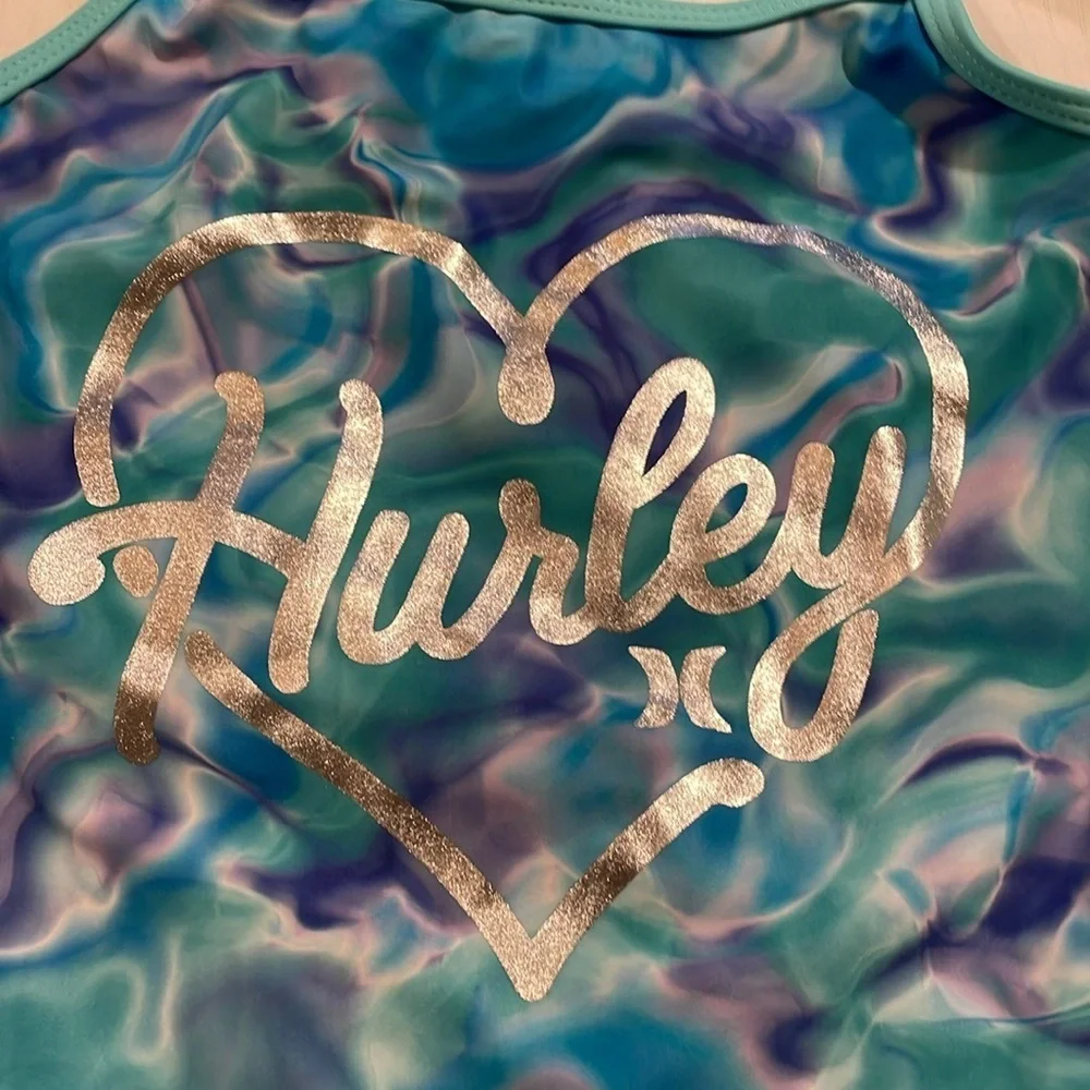 Hurley girls swim one piece. Trimmed in green with swirls of blue/purple. GGG